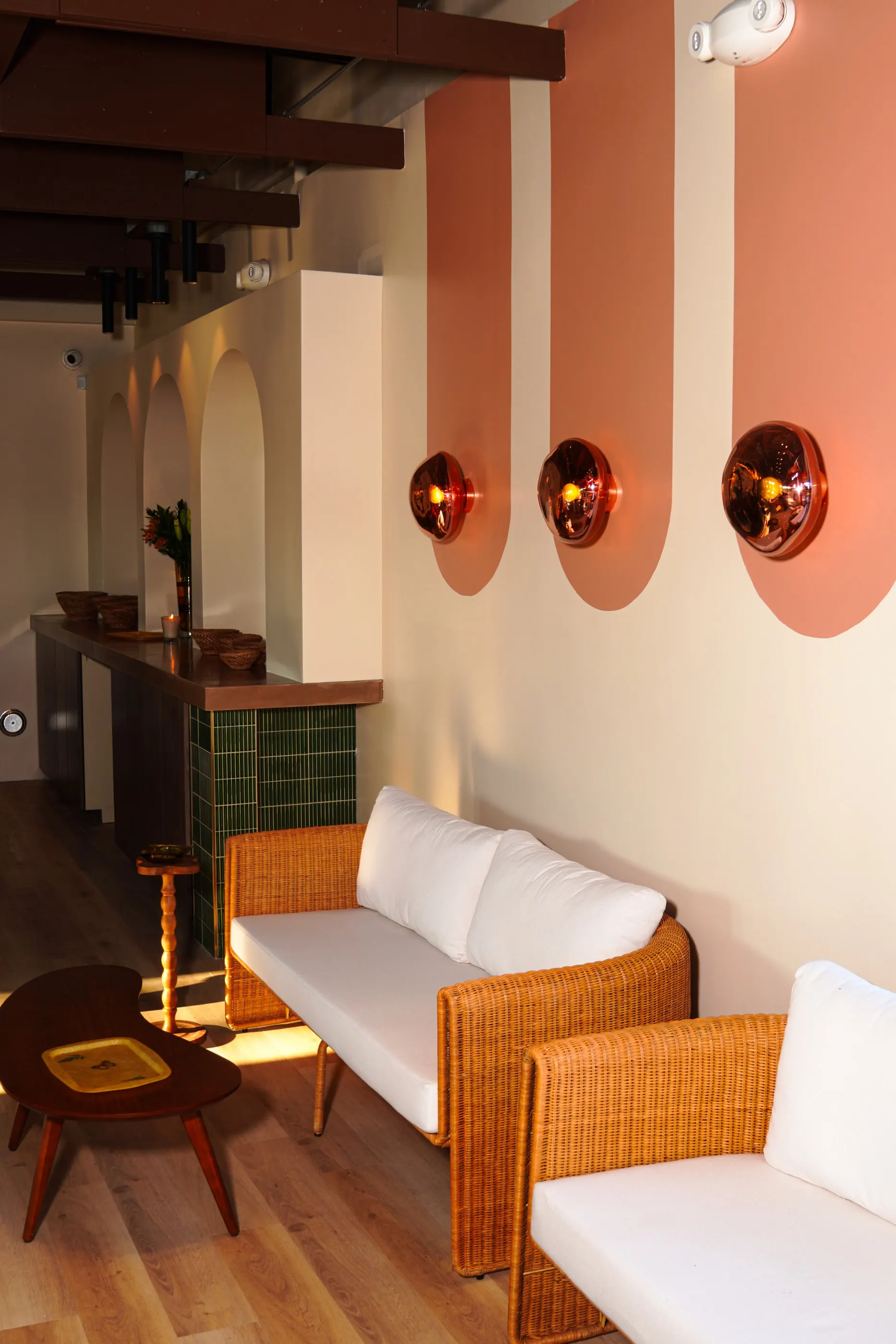 A rattan sofa by the window in Amber Lounge